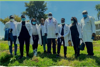 A field team standing together on grassland