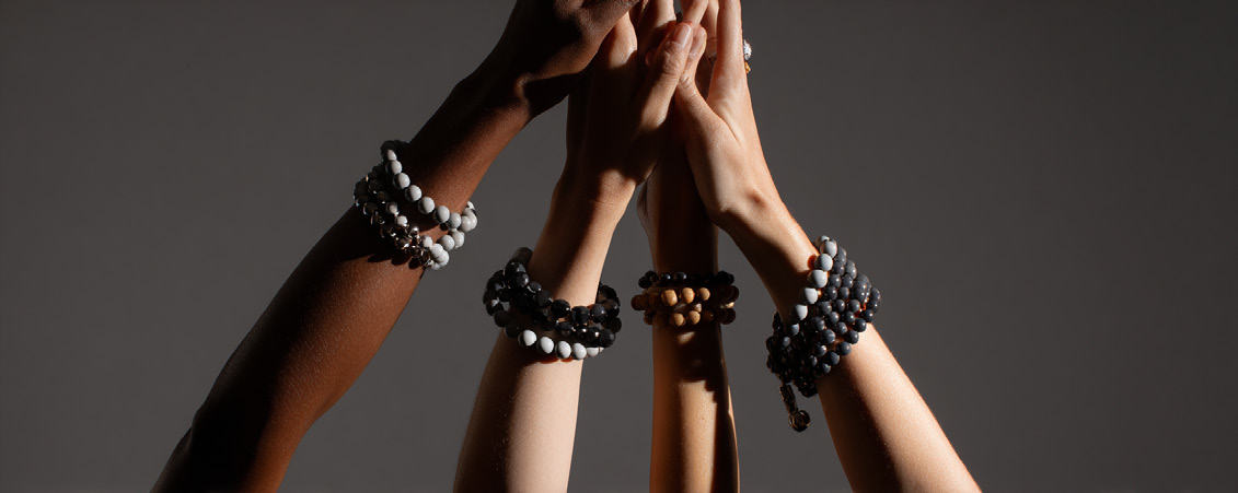 Several hands raised and joined together