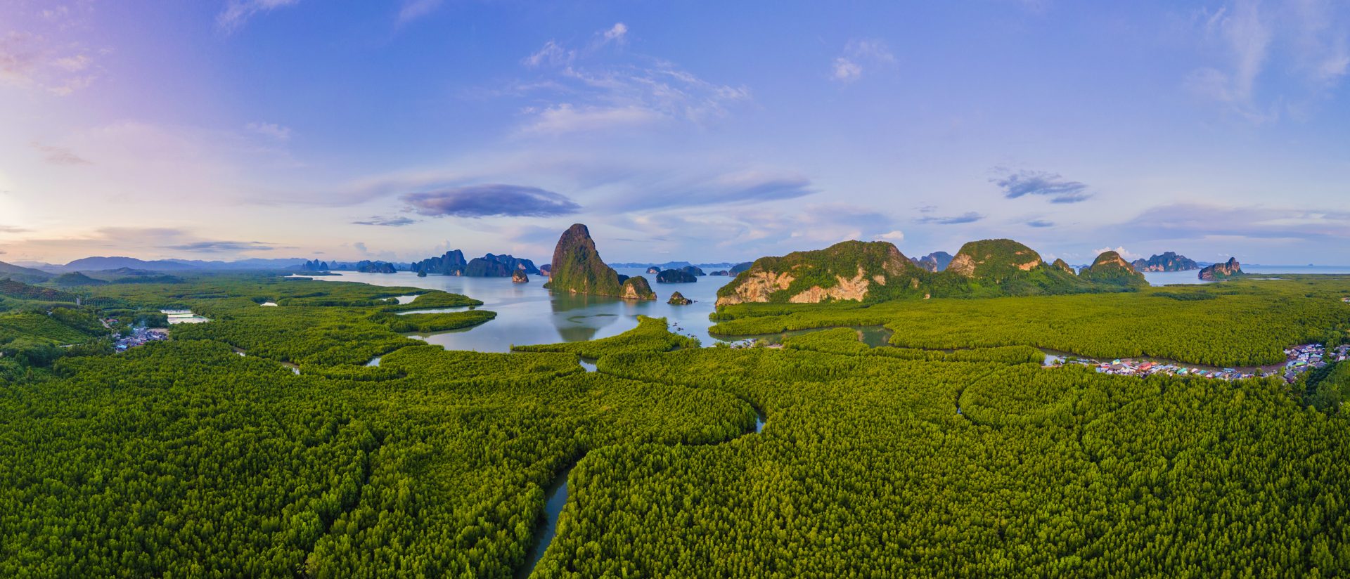 Panoramic view of a lake surrounded by green hills