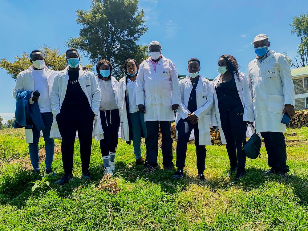 Field team standing together in a green landscape